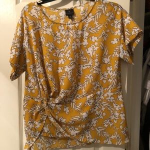Yellow blouse with white flowers